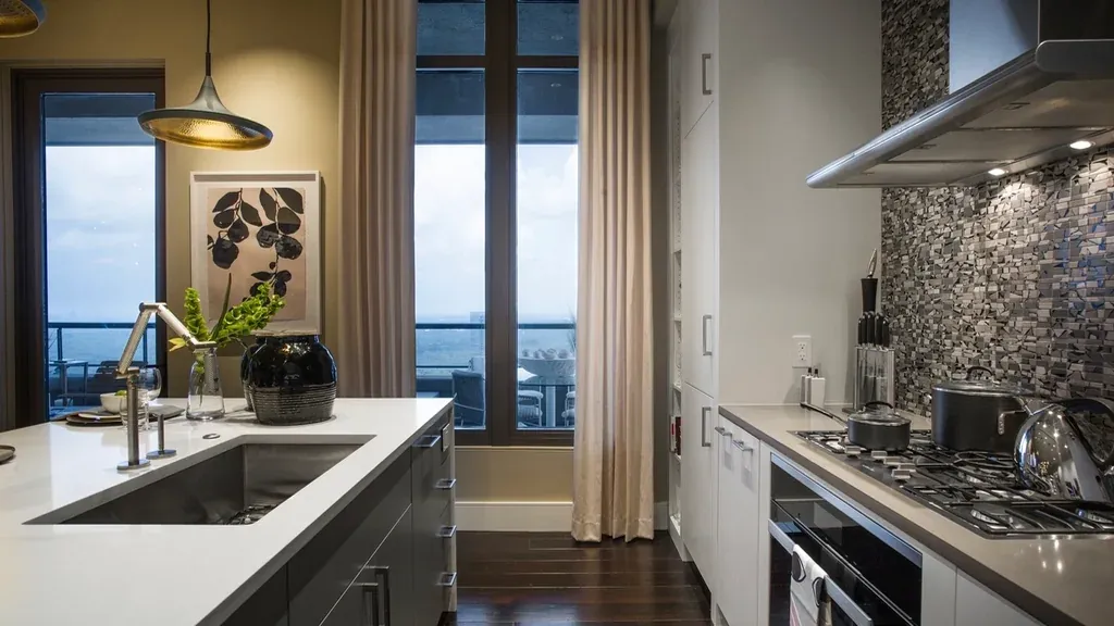 Contemporary kitchen with a white island and city view