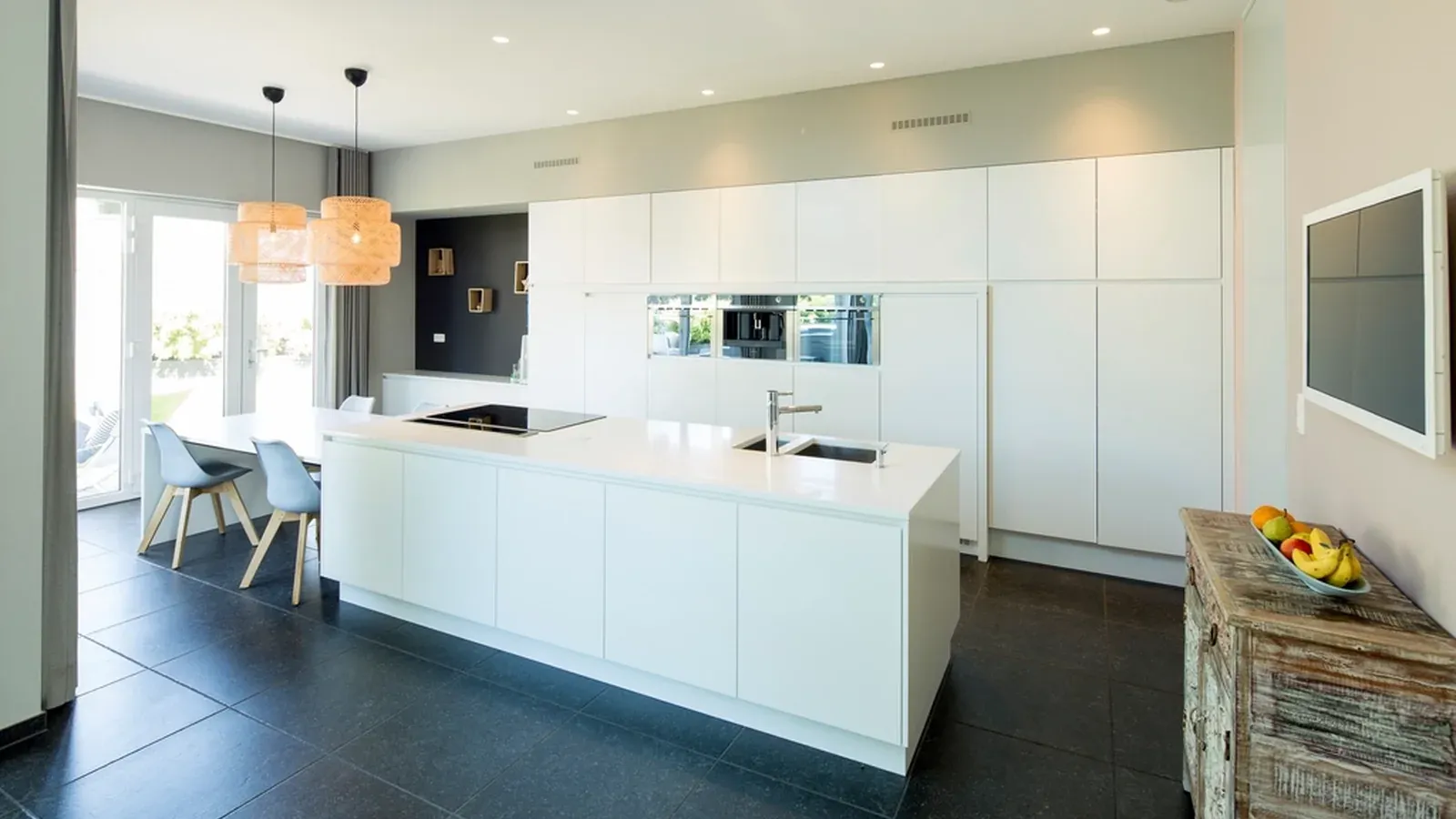 Modern renovated kitchen with a white island and large windows