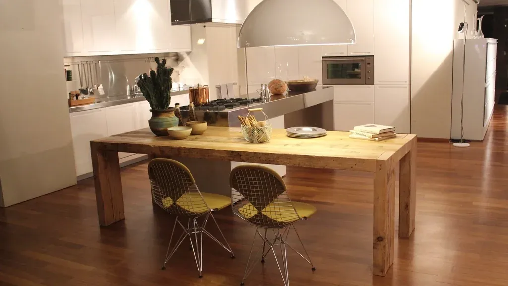 Scandinavian-inspired kitchen with a large wood table and designer chairs