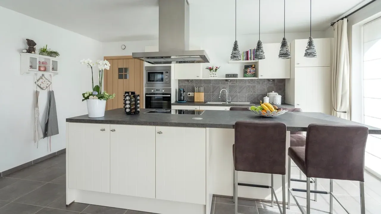 Finished modern kitchen with white cabinets and a centre island