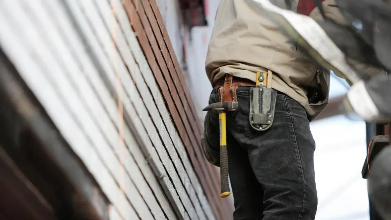 Renovation contractor wearing a tool belt on a job site